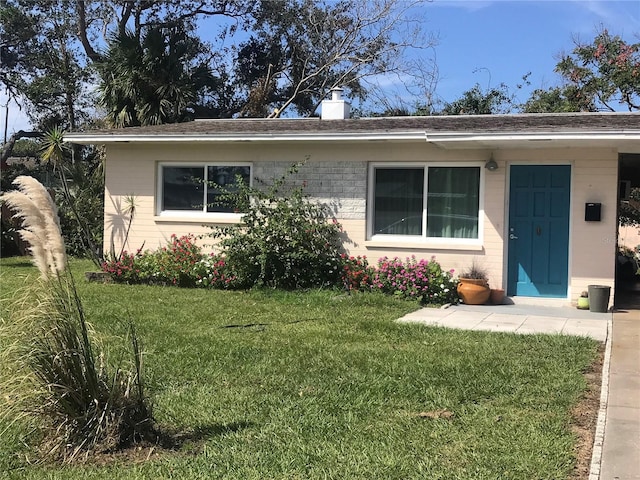 113 Neptune Dr, Edgewater, FL 32132 - ranch-style home with a chimney, brick siding, roof with shingles, and a front yard