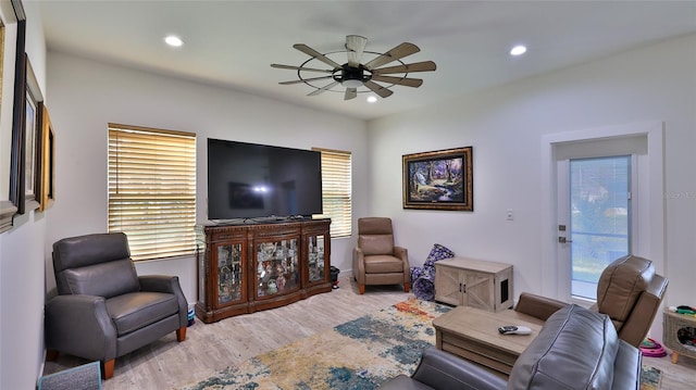 living room featuring ceiling fan and hardwood / wood-style flooring