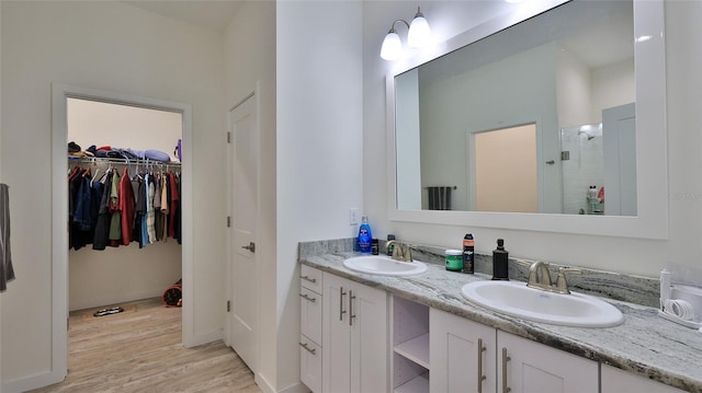 bathroom with vanity, hardwood / wood-style flooring, and a shower with door