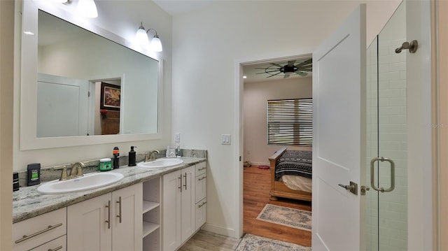 bathroom with vanity, ceiling fan, hardwood / wood-style flooring, and a shower with door