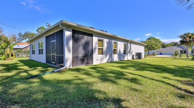 view of property exterior with central AC and a yard