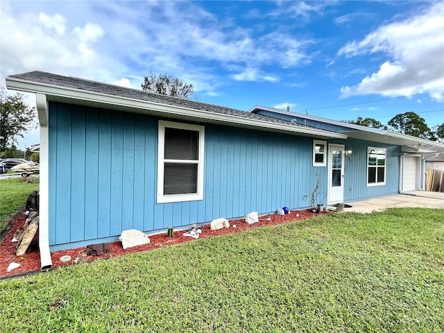 back of property with a patio area and a lawn