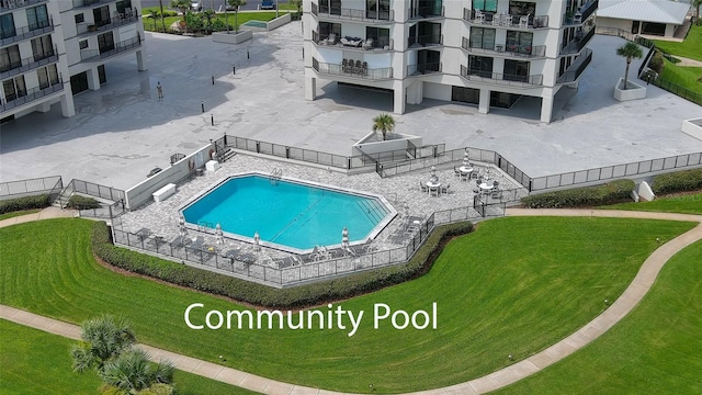 pool with a patio area and a yard