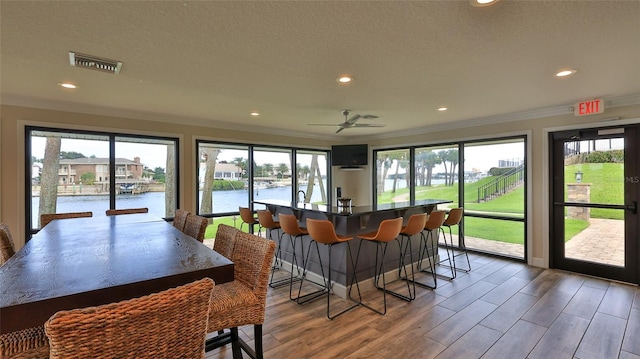 501 N Causeway Unit 2050, New Smyrna Beach, FL 32169 - dining area featuring ornamental molding, recessed lighting, wood finished floors, ceiling fan, and a textured ceiling