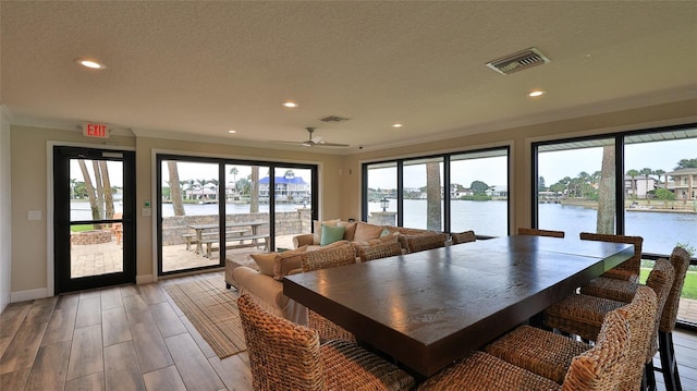 501 N Causeway Unit 2050, New Smyrna Beach, FL 32169 - dining space featuring recessed lighting, a water view, a textured ceiling, baseboards, and a ceiling fan