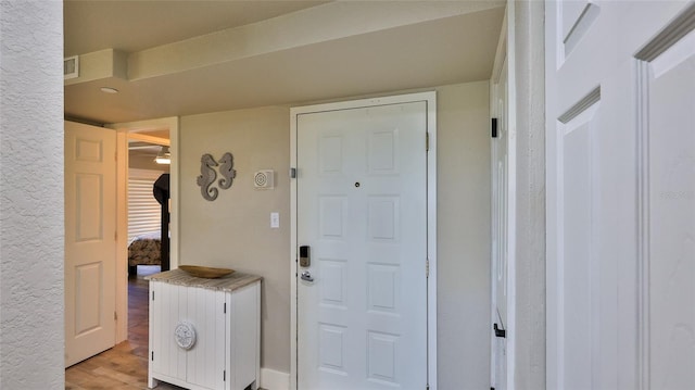 interior space featuring light wood-style floors and visible vents