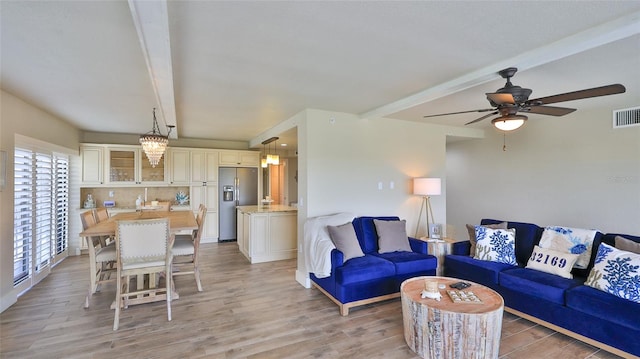 living area featuring a ceiling fan, beam ceiling, visible vents, and light wood-style flooring