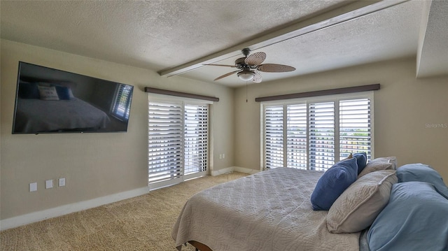 carpeted bedroom featuring a textured ceiling, access to exterior, a ceiling fan, and baseboards