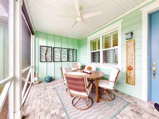 sunroom / solarium featuring ceiling fan