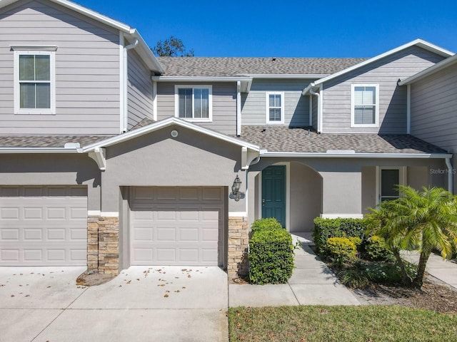 679 Mount Olympus Blvd, New Smyrna Beach, FL 32168 - view of property with concrete driveway, a shingled roof, stone siding, and stucco siding