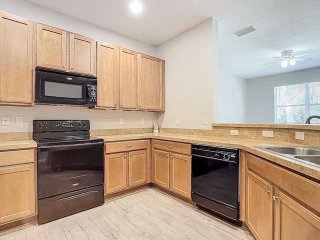 679 Mount Olympus Blvd, New Smyrna Beach, FL 32168 - kitchen with black appliances, light wood-type flooring, light countertops, ceiling fan, and a sink