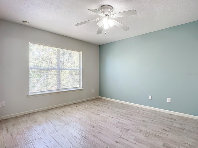 empty room featuring light hardwood / wood-style floors, a textured ceiling, and ceiling fan