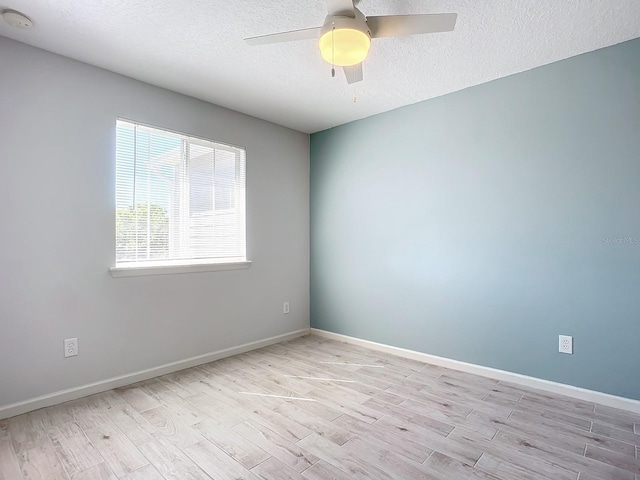 679 Mount Olympus Blvd, New Smyrna Beach, FL 32168 - unfurnished room with wood finished floors, a textured ceiling, a smoke detector, baseboards, and ceiling fan