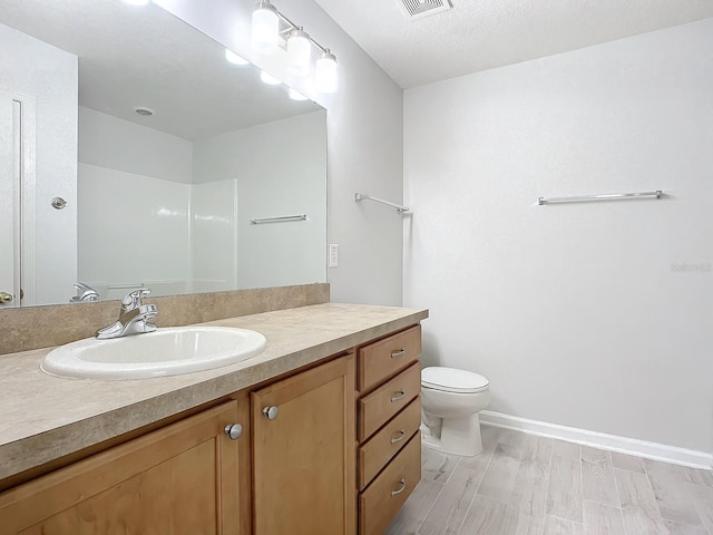679 Mount Olympus Blvd, New Smyrna Beach, FL 32168 - full bathroom with toilet, vanity, wood finished floors, and baseboards