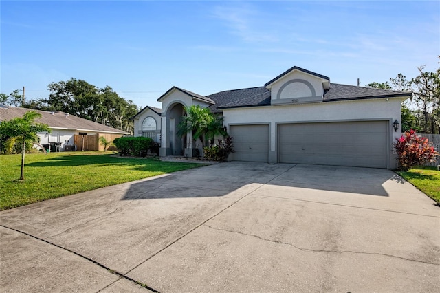 view of front of house with a front yard and a garage