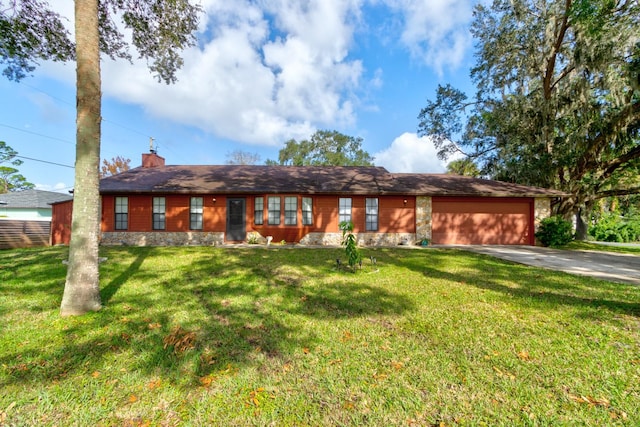 single story home featuring a front lawn and a garage