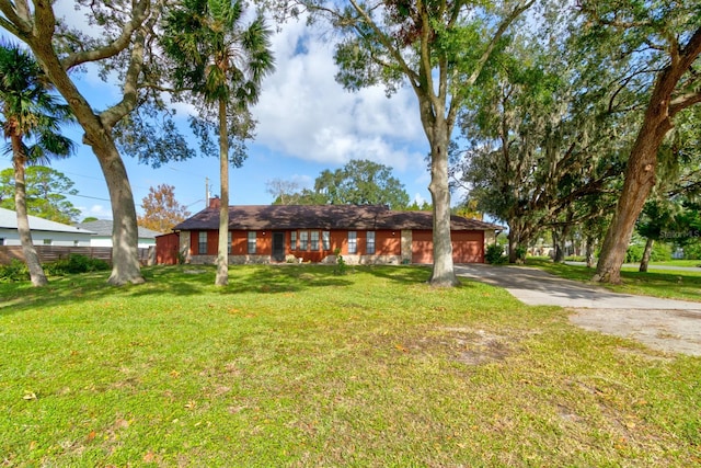 single story home featuring a front yard and a garage