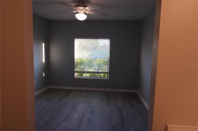 unfurnished room featuring dark wood-type flooring and ceiling fan