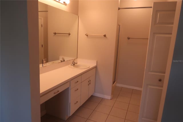 bathroom with vanity, a shower with shower door, and tile patterned flooring