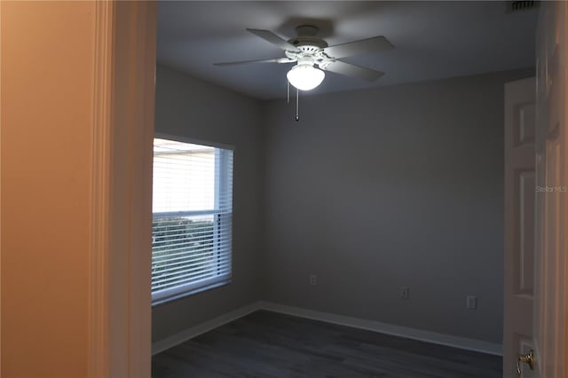 unfurnished room featuring dark wood-type flooring and ceiling fan