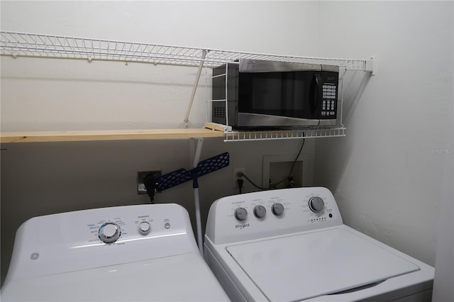 clothes washing area featuring washer and dryer