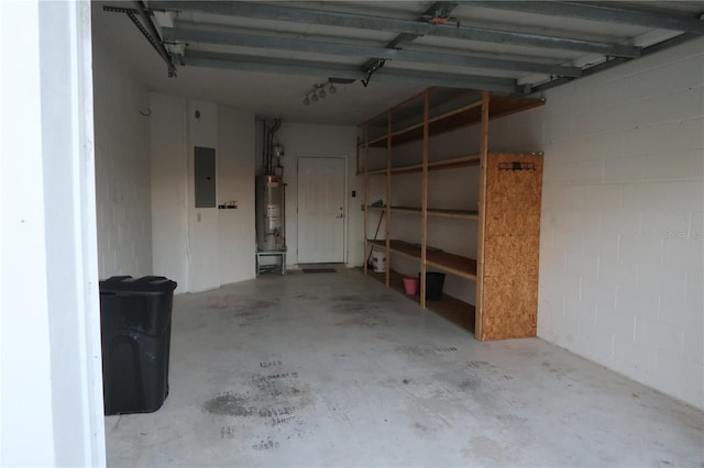 garage featuring water heater and electric panel