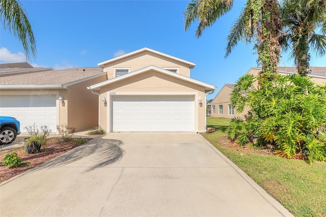 2266 Hawks Cove Cir, New Smyrna Beach, FL 32168 - view of front of house with stucco siding, driveway, and an attached garage