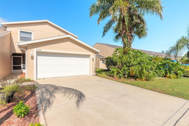 2266 Hawks Cove Cir, New Smyrna Beach, FL 32168 - view of front facade featuring stucco siding, concrete driveway, and a garage