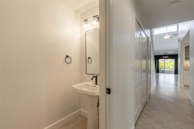 bathroom featuring ceiling fan, tile patterned floors, and sink