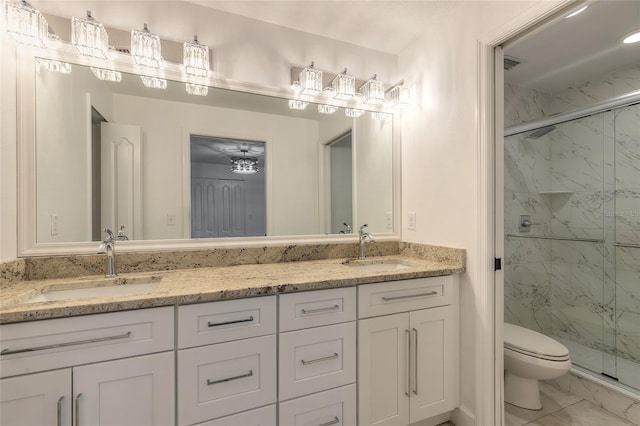 bathroom with toilet, a shower with shower door, and vanity