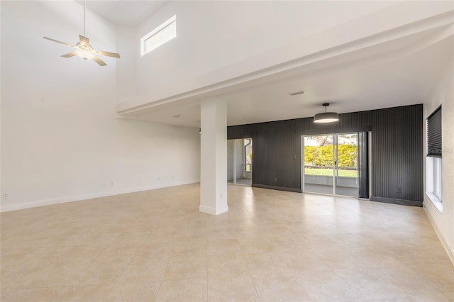 2266 Hawks Cove Cir, New Smyrna Beach, FL 32168 - unfurnished living room featuring plenty of natural light, light tile patterned flooring, and a ceiling fan