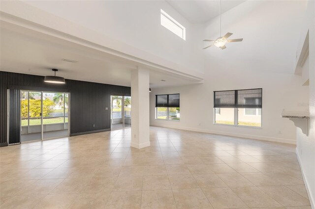2266 Hawks Cove Cir, New Smyrna Beach, FL 32168 - unfurnished living room featuring ceiling fan, light tile patterned floors, and baseboards