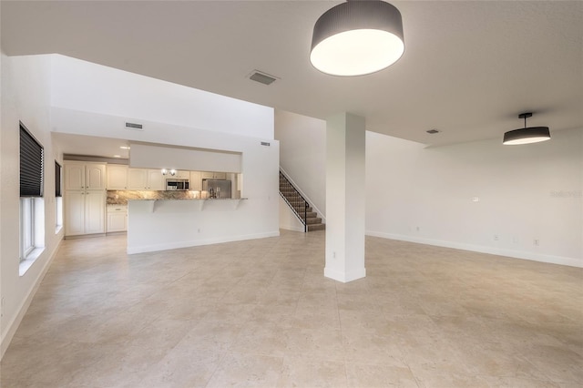 unfurnished living room with light tile patterned floors