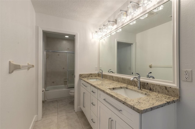 full bathroom with tile patterned floors, toilet, vanity, enclosed tub / shower combo, and a textured ceiling