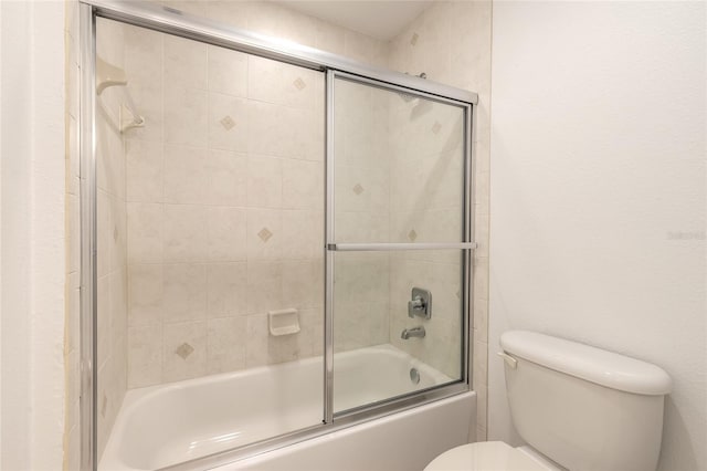 bathroom with toilet and enclosed tub / shower combo