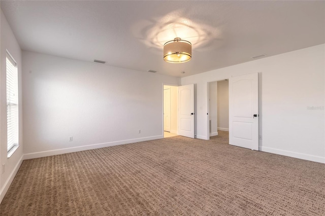 2266 Hawks Cove Cir, New Smyrna Beach, FL 32168 - unfurnished bedroom featuring baseboards and carpet flooring