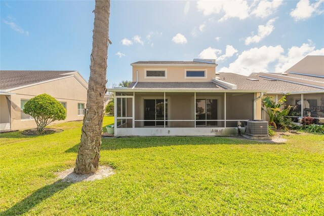 2266 Hawks Cove Cir, New Smyrna Beach, FL 32168 - back of house with a sunroom, roof with shingles, a yard, and central air condition unit