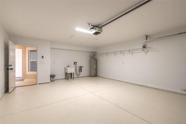 garage featuring a garage door opener, electric water heater, and sink