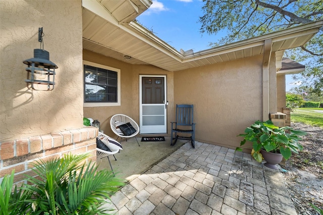 entrance to property featuring a patio