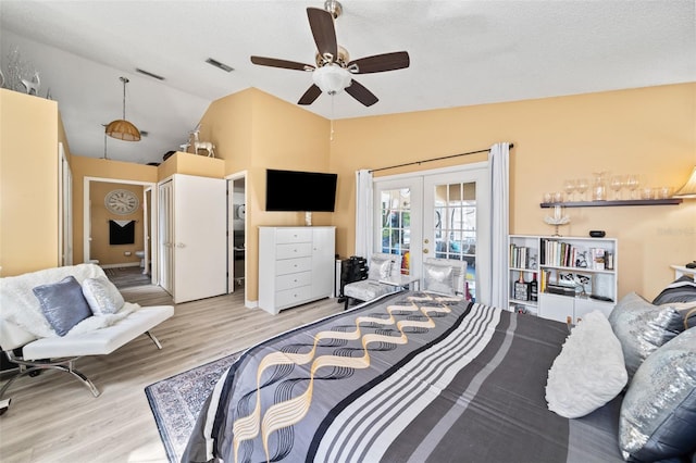 bedroom with lofted ceiling, french doors, access to outside, light wood-type flooring, and ceiling fan