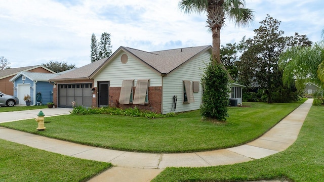 single story home with a front lawn, a garage, and central AC unit