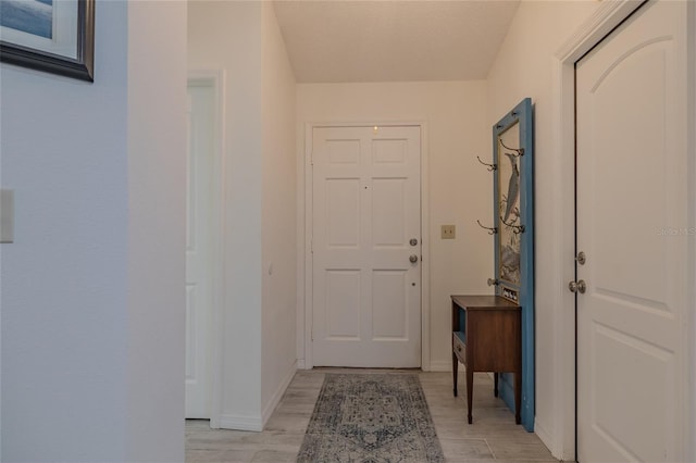 doorway to outside featuring a textured ceiling