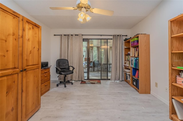 home office with ceiling fan, a textured ceiling, and light hardwood / wood-style flooring