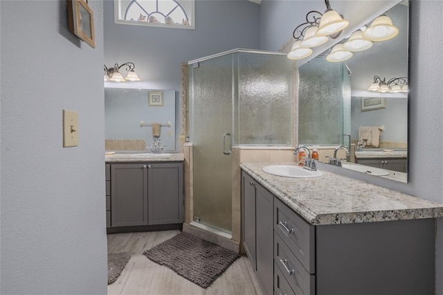 bathroom featuring an enclosed shower, vanity, and hardwood / wood-style floors