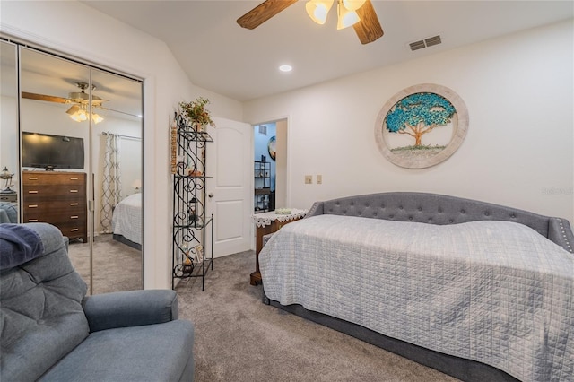 carpeted bedroom featuring ceiling fan and a closet