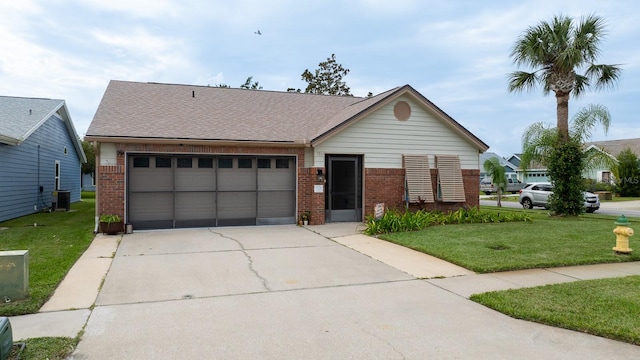 single story home featuring a garage and a front yard