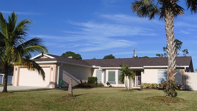 ranch-style home featuring a garage and a front lawn