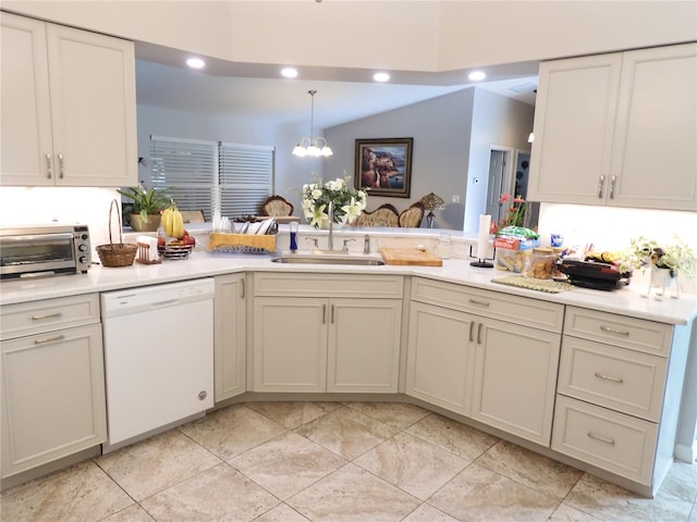 kitchen featuring kitchen peninsula, white dishwasher, vaulted ceiling, sink, and decorative light fixtures