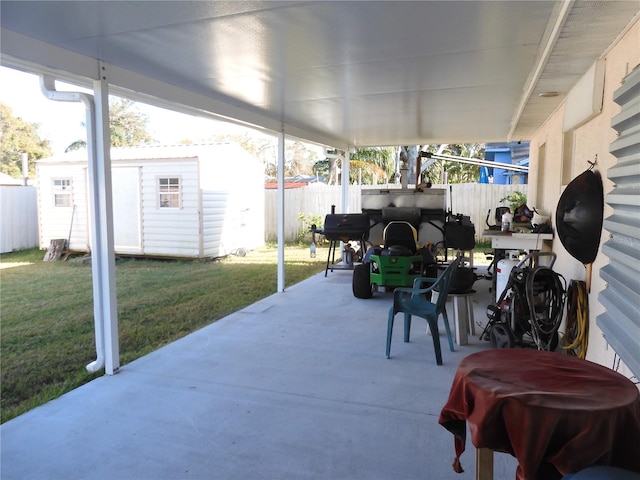 view of patio with a storage shed and area for grilling