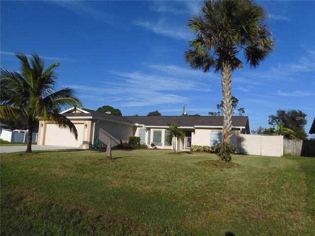 single story home featuring a garage and a front lawn